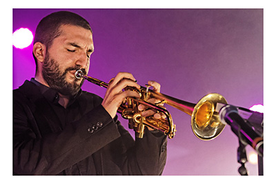 Trumpeter playing into a microphone